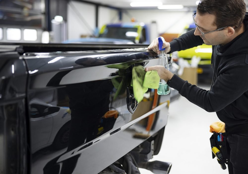medium-shot-man-cleaning-car